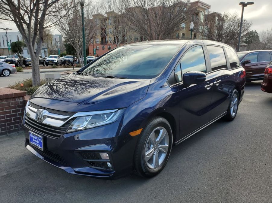 The front end of a dark blue honda odyssey mini van