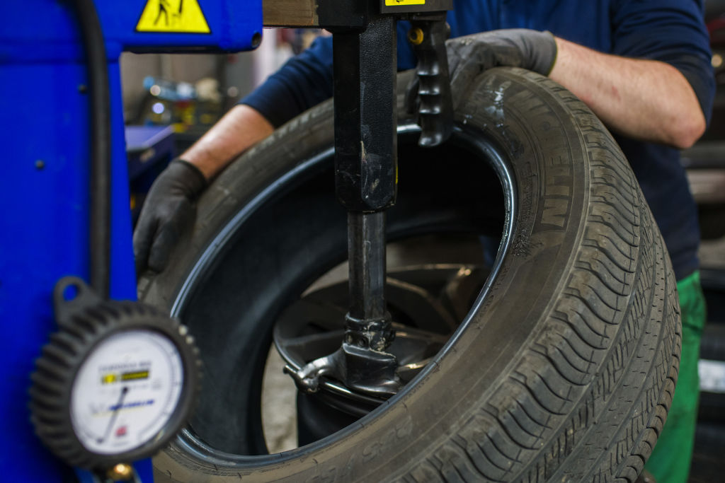 A Michelin tire being mounted onto a wheel hub