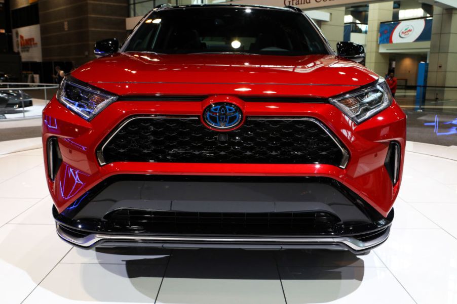 The front end of a red toyota rav4