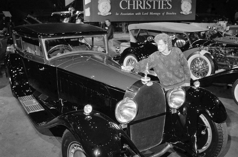 A man gives a 1931 Bugatti Royale Kellner Coupe a final polish at London's Royal Albert Hall before a Christie's auction