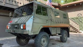 Bob Lutz's olive-green 1973 Steyr-Puch Pinzgauer 710M in front of a brown house