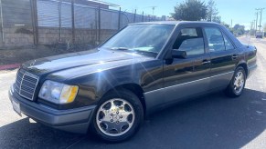 A black 1995 Mercedes-Benz E320 in a sunny street