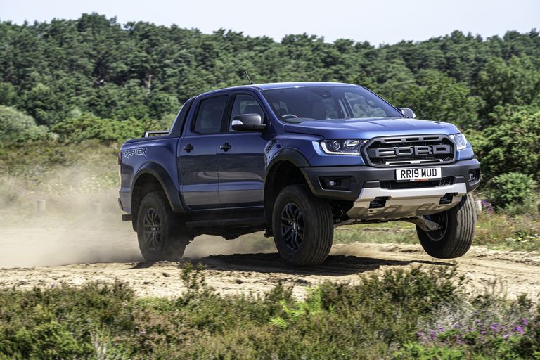 Ford Ranger Raptor jumping on a scenic sandy off-road trail 