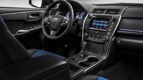 The black and blue interior of a 2016 Toyota Camry midsize sedan