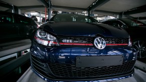 A dark-blue 2016 Volkswagen Golf GTI hatchback sits in a storage bay at a VW factory in Germany in April 2016