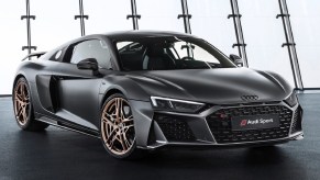 A matte-black 2020 Audi R8 V10 Decennium with bronze wheels in a well-lit area