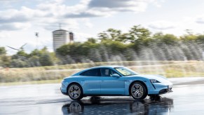 A sky-blue Porsche Taycan 4S electric sedan at the Taycan Regional Tour 2020 in Lüneburg, Germany