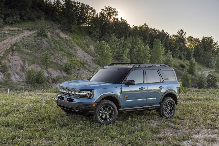 A blue 2021 Ford Bronco Sport Badlands parked on the grass next to a hill in Area 51