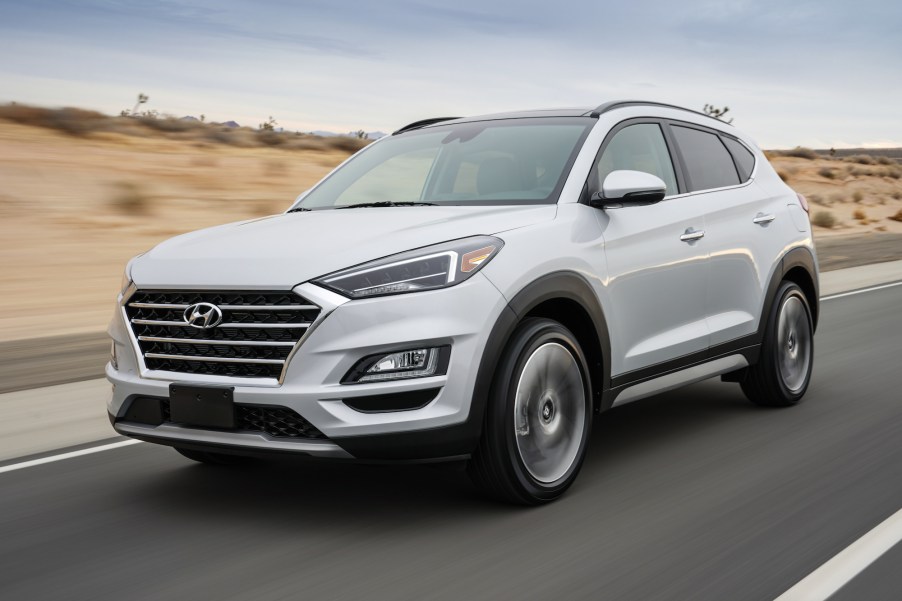 A white 2021 Hyundai Tucson compact crossover SUV traveling on a desert highway