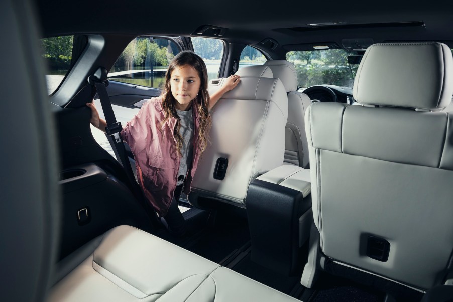 A girl looks inside a 2021 Mazda CX-9 SUV