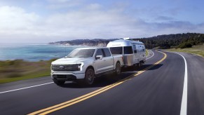 The 2022 Ford F-150 Lightning Lariat seen towing an RV, the F-150 Lightning is Ford's first electric pickup truck