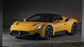 A yellow 2022 Maserati MC20 in a garage