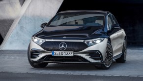 A silver and black 2022 Mercedes-Benz EQS electric sedan parked in a gray showroom