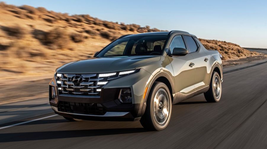 The 2022 Hyundai Santa Cruz driving down a road in the desert.