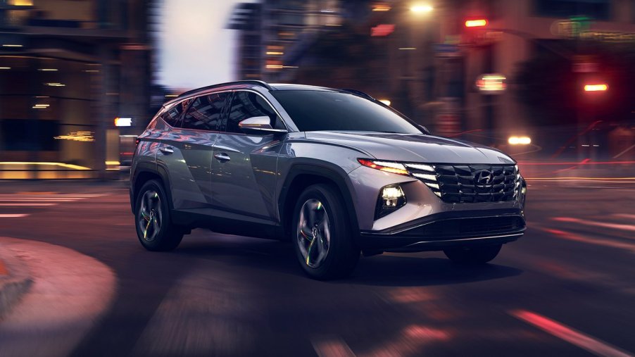 a silver 2022 Hyundai Tucson SUV in the street at dusk