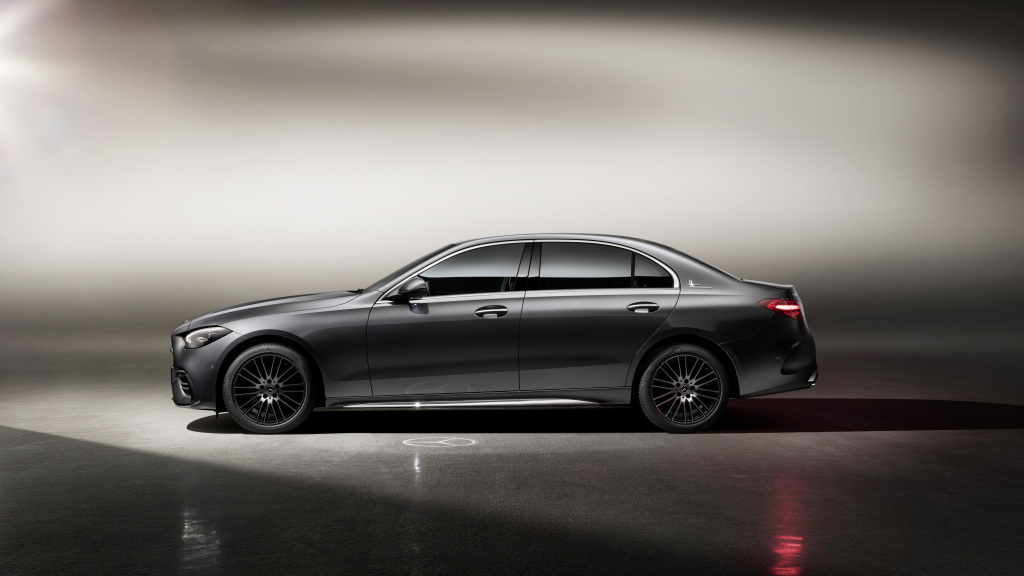 The new Mercedes C-Class in grey sits in a photo booth photographed in profile