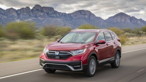 A red 2021 Honda CR-V Hybrid driving