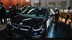 A staff cleans a BMW THE i3 car at the Beijing Auto Show in Beijing