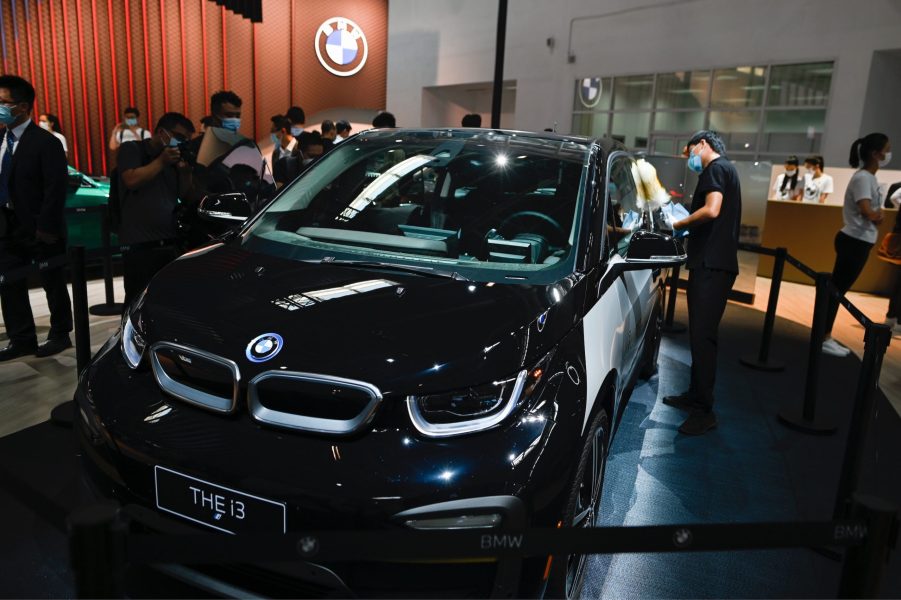 A staff cleans a BMW THE i3 car at the Beijing Auto Show in Beijing