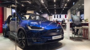 American electric company car Tesla Motors official authorized car dealer store as it displays the blue Model X