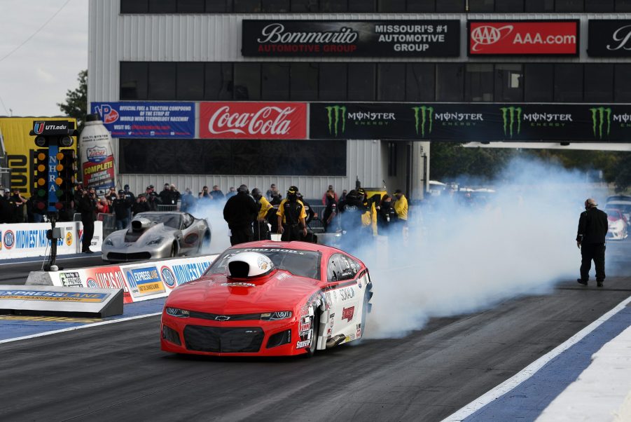 A Chevy does a burnout during a drag race.