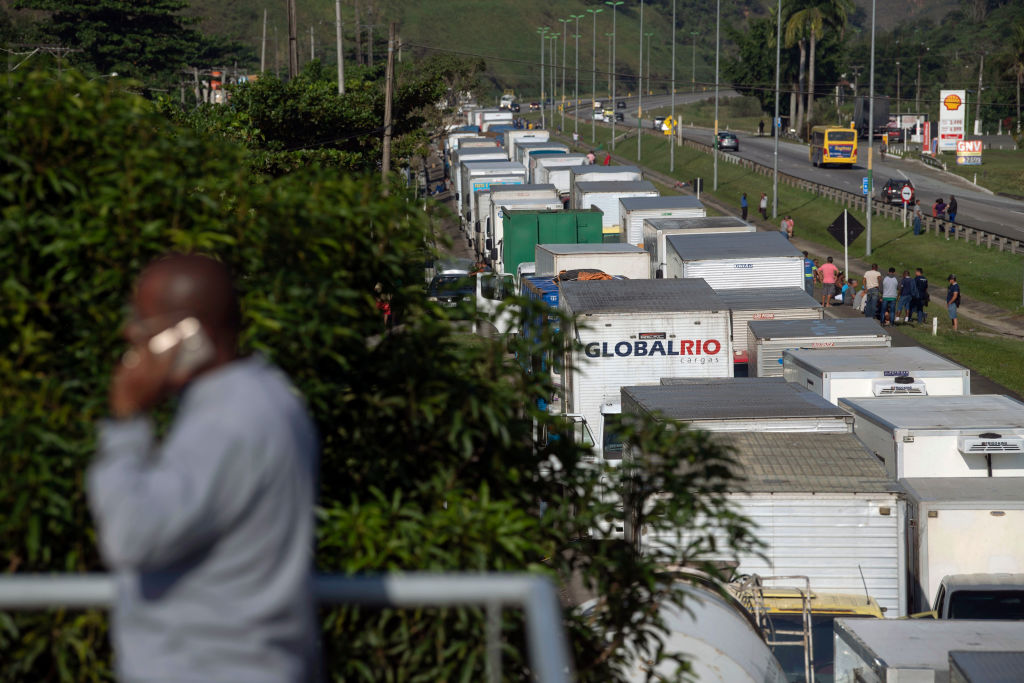 semi-trucks lined up on the highway