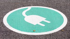 an EV charging symbol on pavement