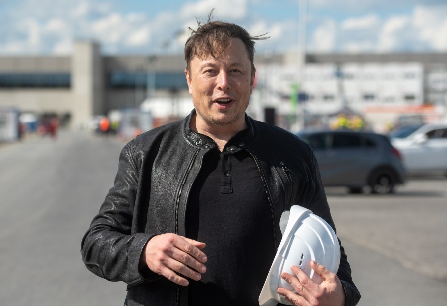 Tesla CEO Elon Musk holds a white hard hat as he stands on the construction site of the Tesla factory in Grünheide, Germany, on May 17, 2021