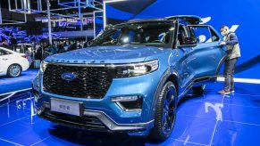 A blue 2021 Ford Explorer on a showroom floor.