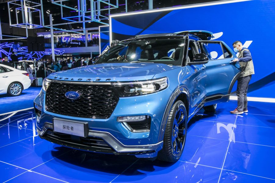 A blue 2021 Ford Explorer on a showroom floor.