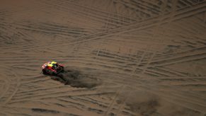 A Ford F-150 Raptor pickup truck in a desert rally