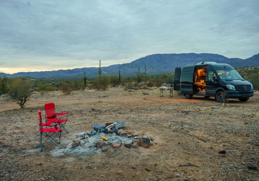 the camper van style of RV, which is among the most fuel-effcient RV models, parked at a scenic desert campsite