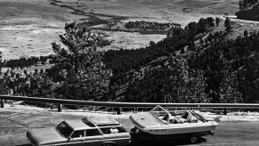 A small car towing a power boat