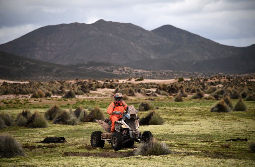 A professional riding a quad made by the Yamaha ATV brand off-road in the Dakar Rally. 