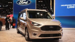 a silver ford transit connect at an auto show