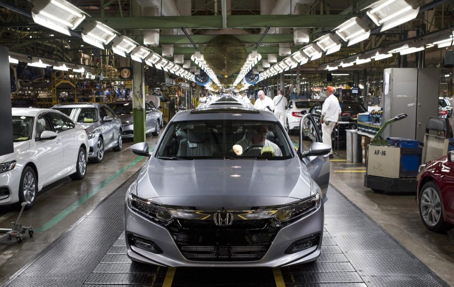 An employee prepares to drive a silver 2018 Honda Accord vehicle off the assembly line at the Honda of America Manufacturing Inc. Marysville Auto Plant