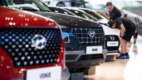 A red Hyundai Motor Co. Venue compact sport utility vehicle (SUV), center, stands on display at the company's Motorstudio showroom in Goyang, South Korea