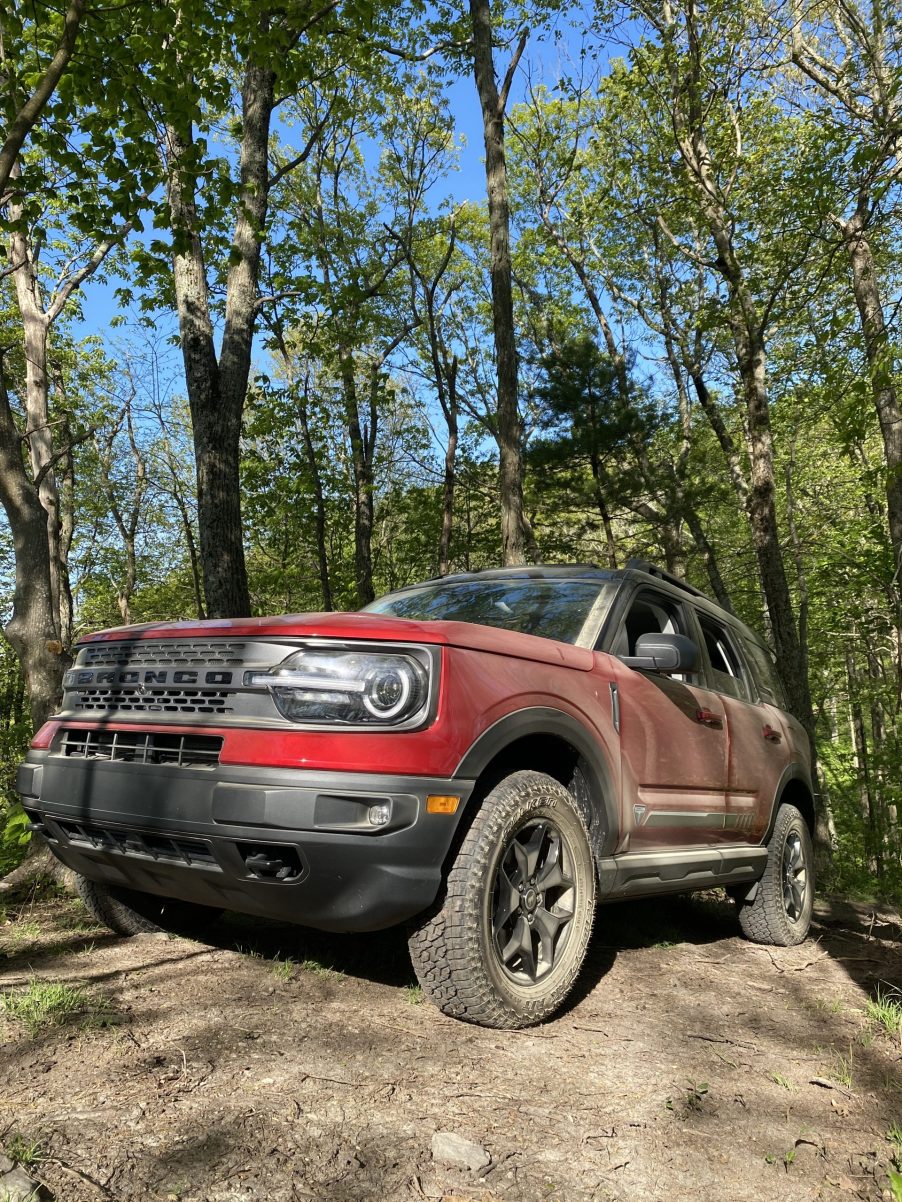 A red 2021 Ford Bronco Sport parked on top of a rock