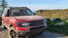 A red 2021 Ford Bronco Sport parked in front of a mountain view