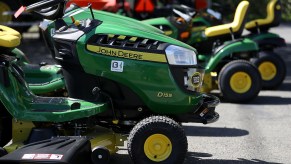 A lineup of John Deere riding lawn mowers, John Deere is one of the most reliable lawn mower brands