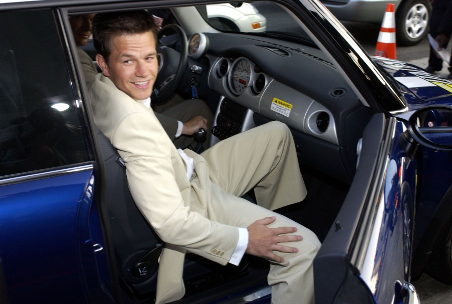 Actor Mark Wahlberg sits in a blue car outside Grauman's Chinese Theatre in Hollywood, California, during the world premiere of the film 'The Italian Job'