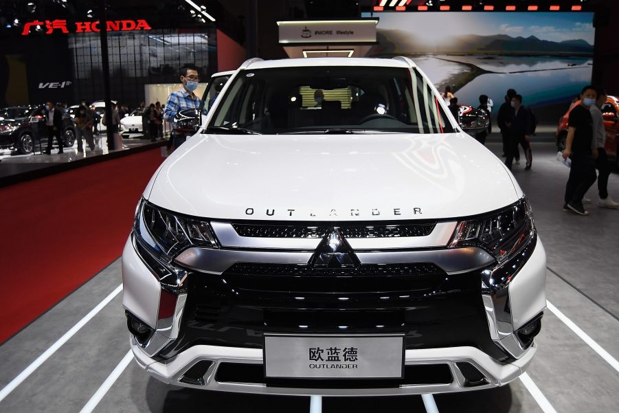 A white Mitsubishi Outlander car is displayed during the 19th Shanghai International Automobile Industry Exhibition