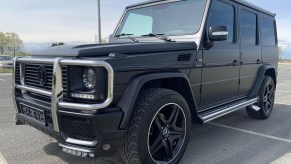 A modified matte-black 1995 Mercedes-Benz G320 in a parking lot