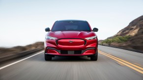 A red 2021 Ford Mustang Mach-E driving