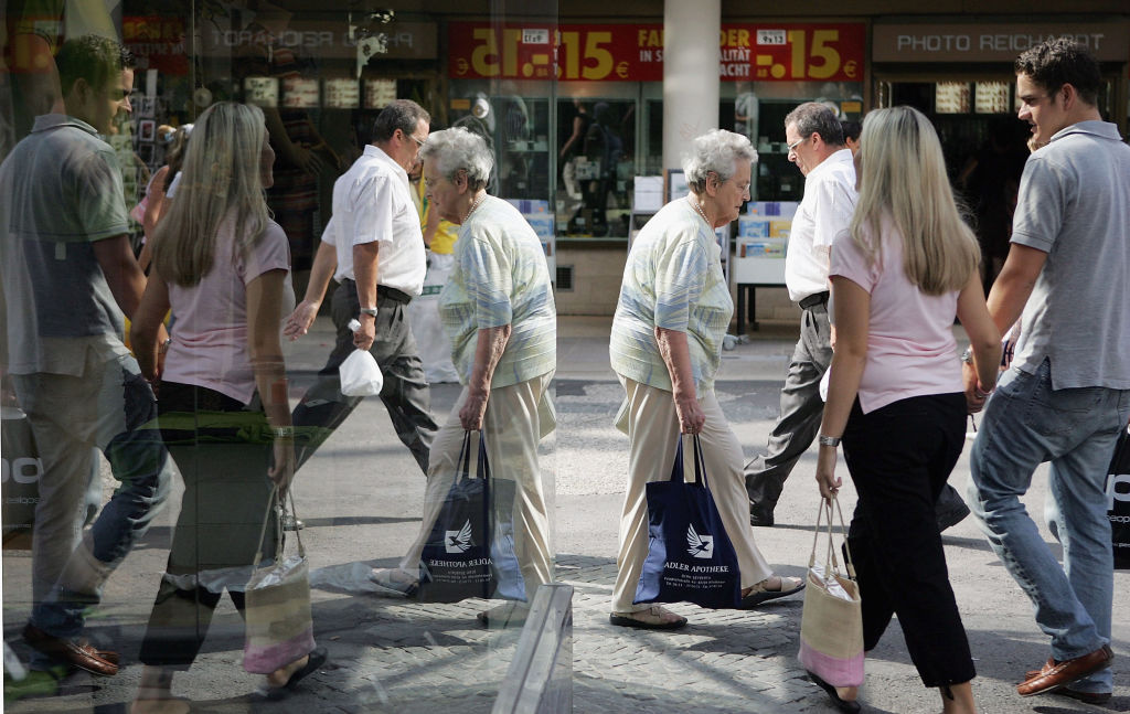 Pedestrians reflected in window