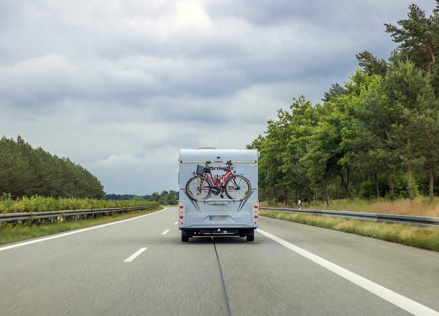 An RV driving down the road with proper RV tires fitment heading to summer vacation