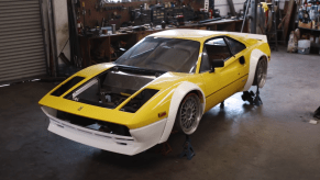 An image of a widebody Ferrari in a workshop.