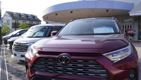 A red Toyota Motor Corp. RAV4 sports utility vehicle (SUV) at the company's dealership in Yokohama, Japan