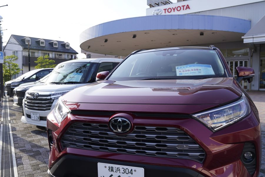 A red Toyota Motor Corp. RAV4 sports utility vehicle (SUV) at the company's dealership in Yokohama, Japan