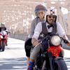 Two riders dressed in vintage clothing ride over a NYC bridge at the 2018 Distinguished Gentleman's Ride